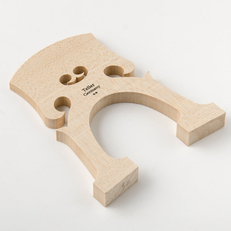 Close-up detail of Josef Teller cello bridge showing aged maple grain and professional craftsmanship