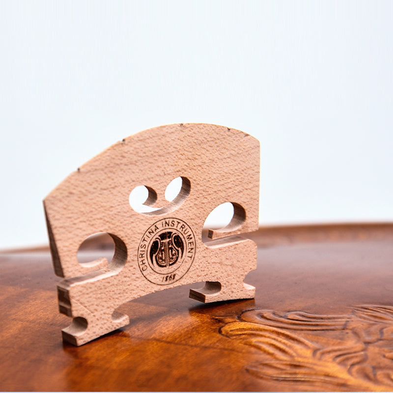 Close-up of violin bridge replacement with precision cut maple design for improved sound projection